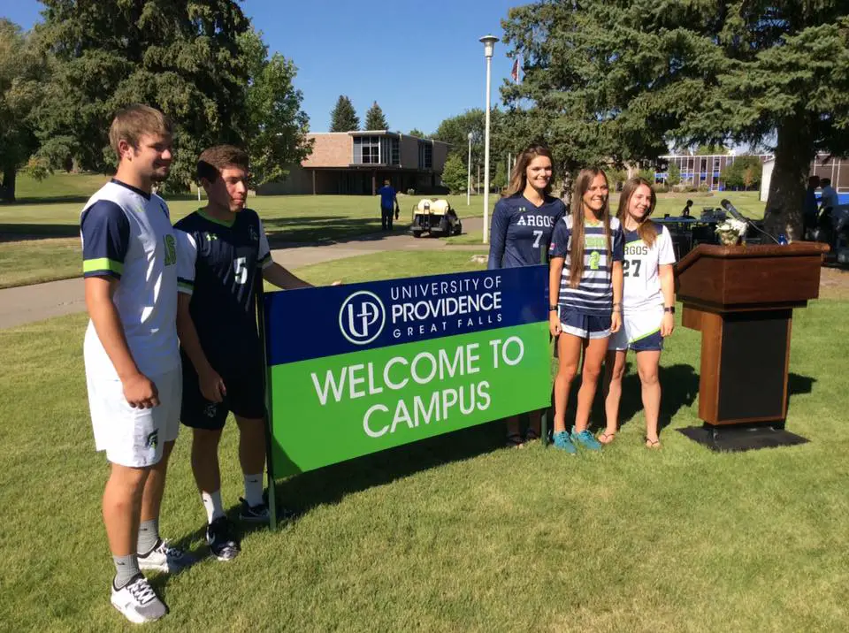 Students welcoming visitors to the University of Providence campus.