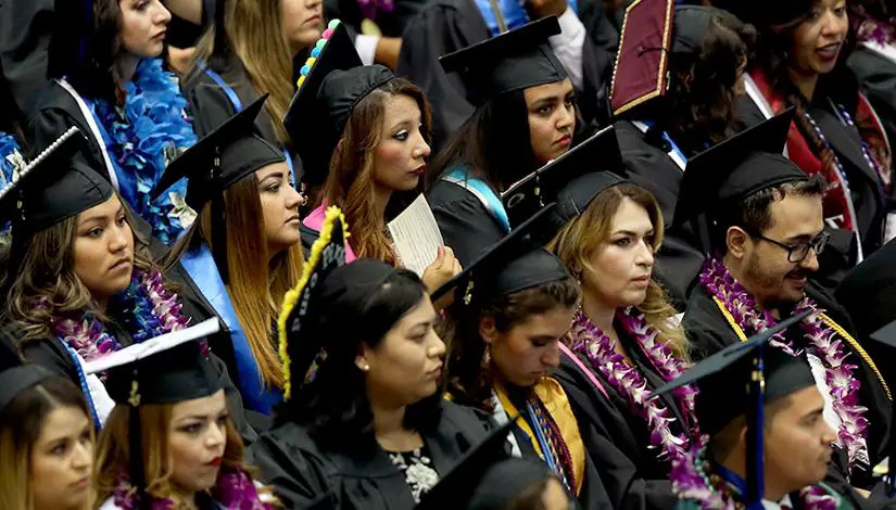 A group of Hispanic students at a graduation ceremony.