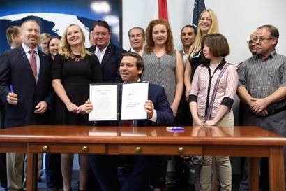 Florida Governor Ron DeSantis signing a bill.