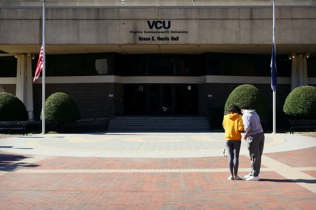 Two students stand in front of Virginia Commonwealth University Grace E. Harris Hall