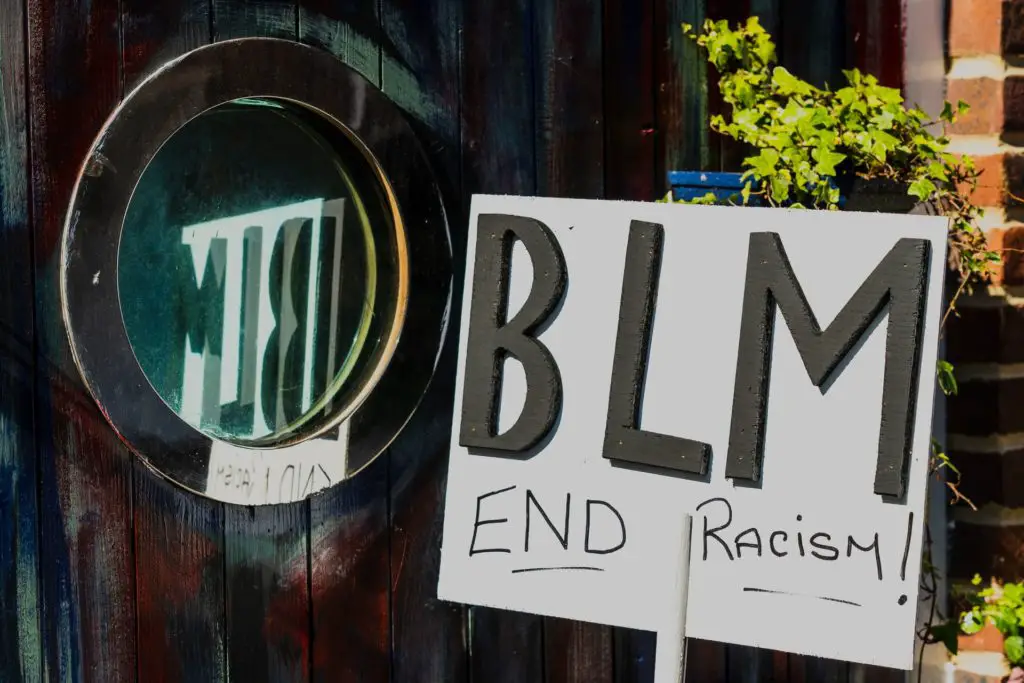 A sign reading "BLM. End Racism!"