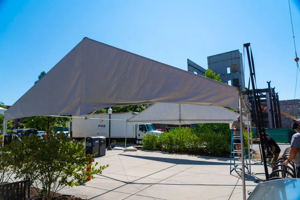 Crews install tents over designated outdoor spaces at Virginia Tech where students will be to study and work on projects between classes