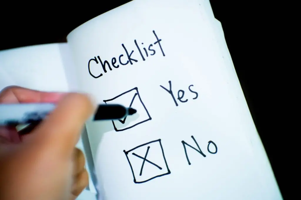 Person marking checks on a checklist.