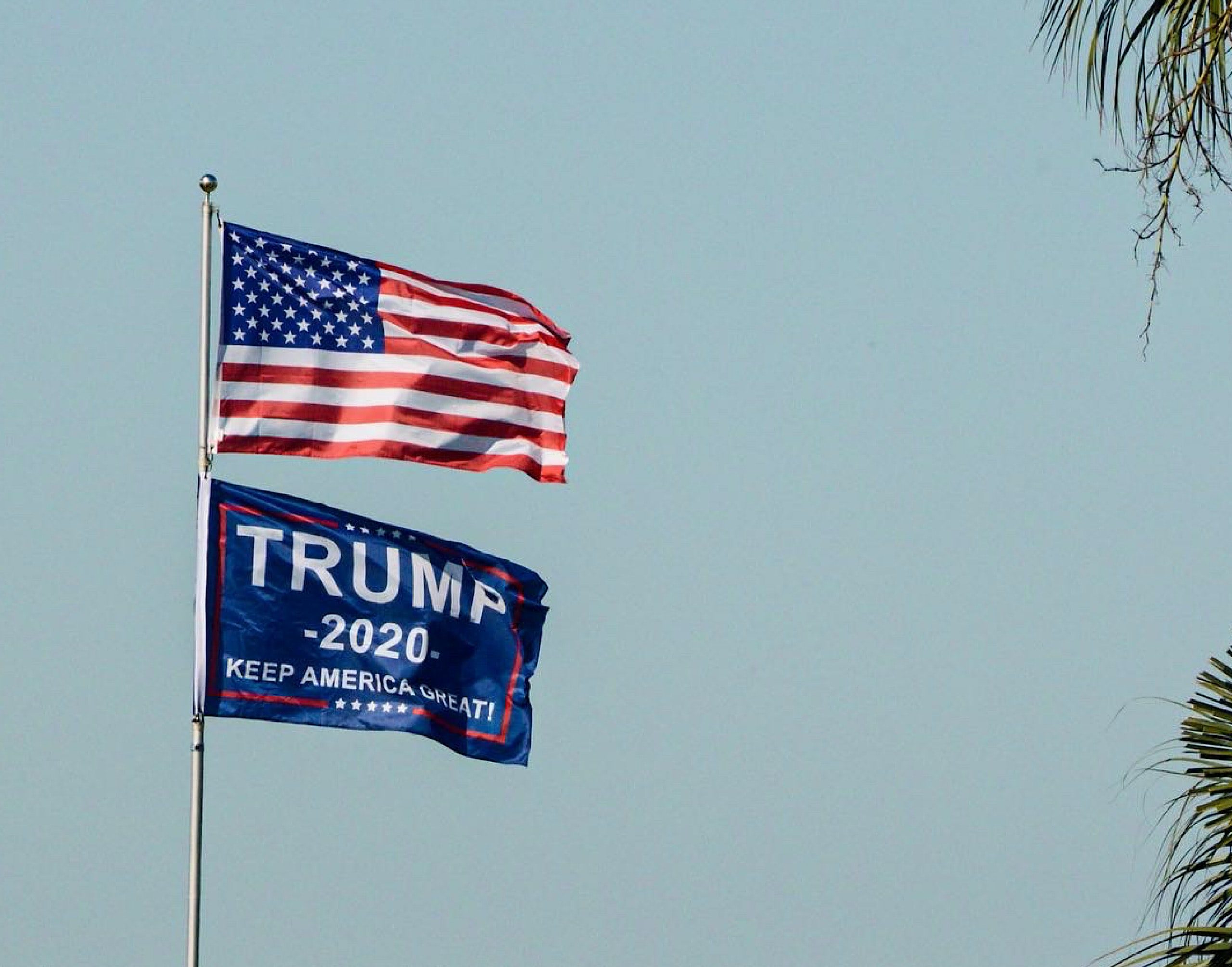 Photo showing an American flag and a Trump 2020 flag