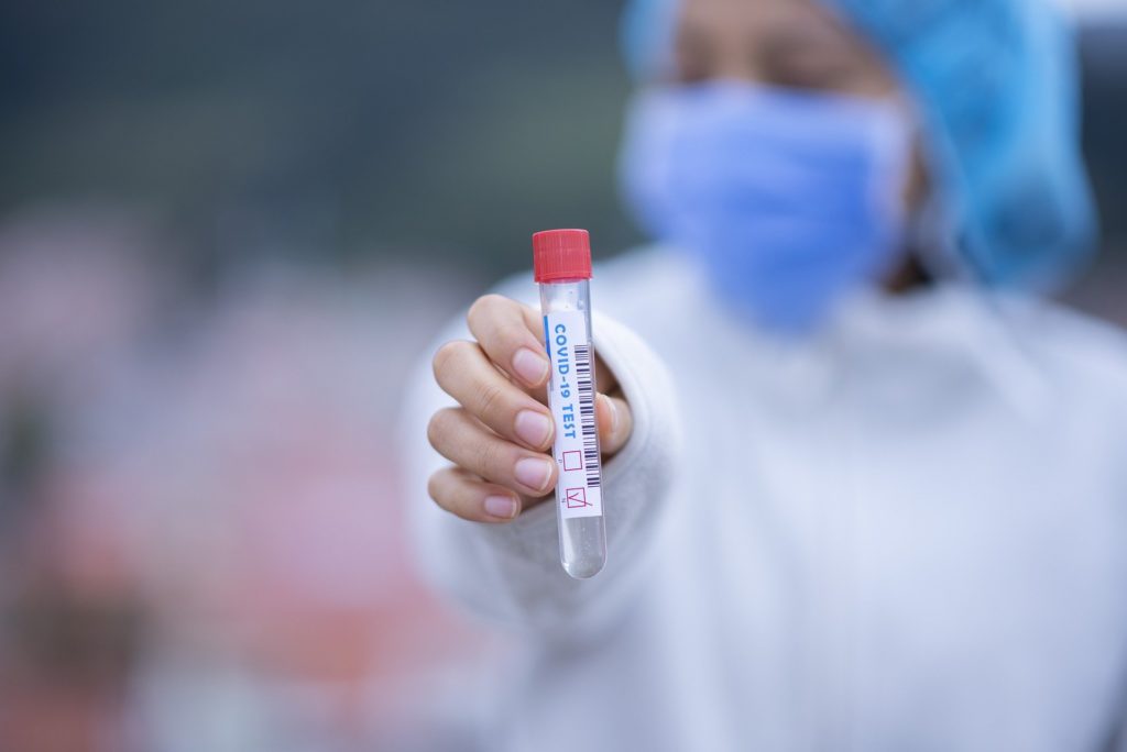 Photo of a medical worker holding a negative COVID-19 test