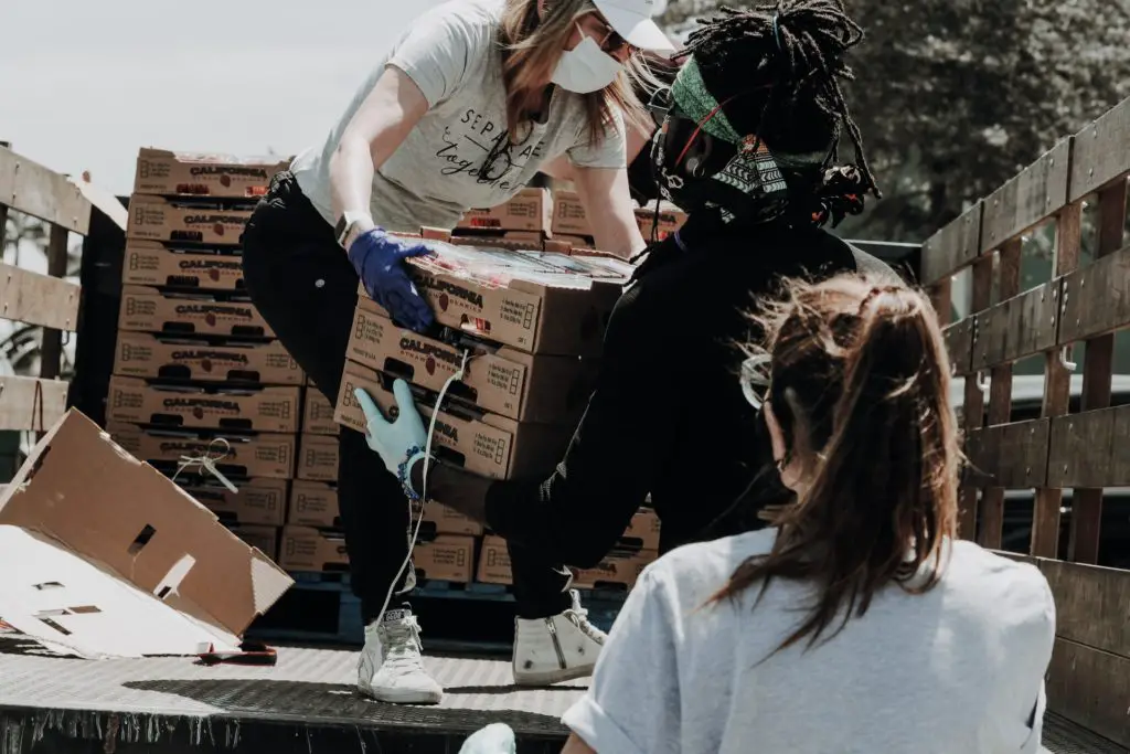 Photo of someone handing out a box of food