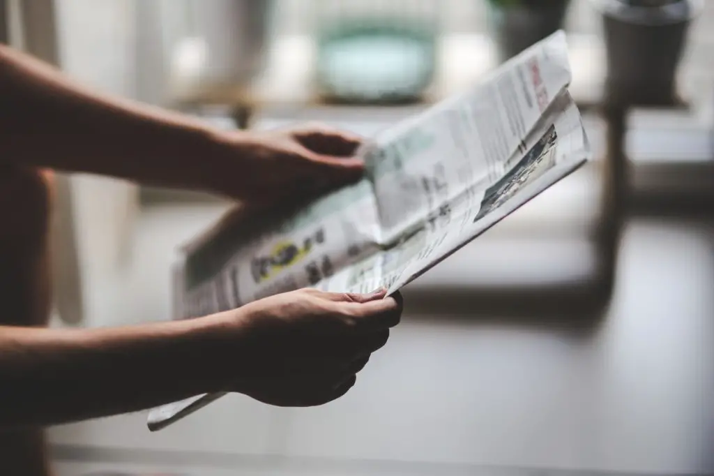 Photo of someone holding a newspaper