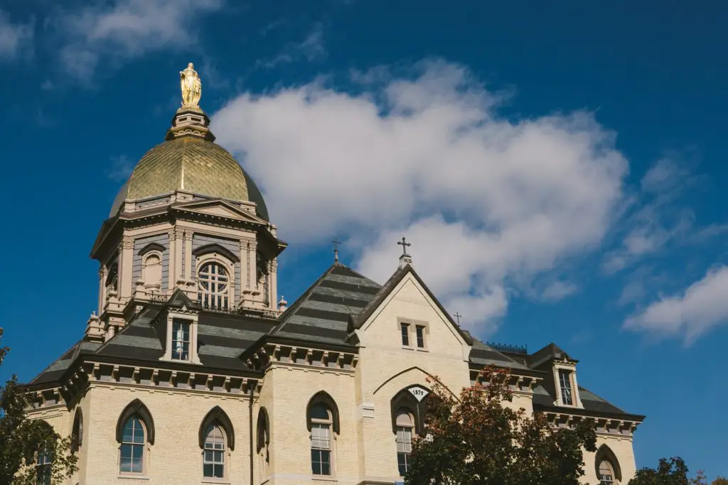 Mid shot of the Statue of Mary and the Golden Dome on top of Notre Dame University Administration Building