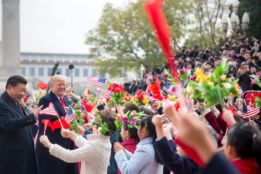 President Donald Trump and President Xi Jinping meet children waving Chinese and US flags at welcoming ceremonies outside the Great Hall of the People, Thursday, November 9, 2017, in Beijing