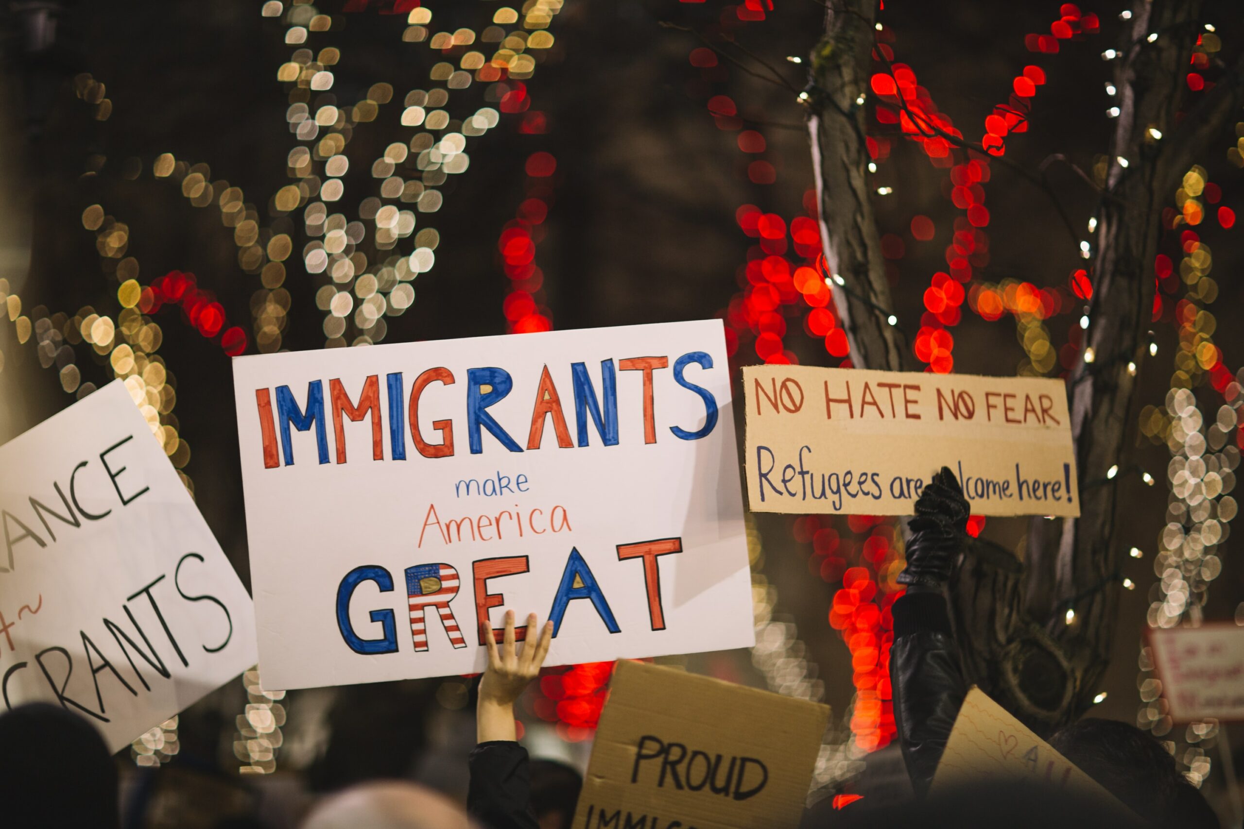 Protestors with signs reading "Immigrants make America Great"