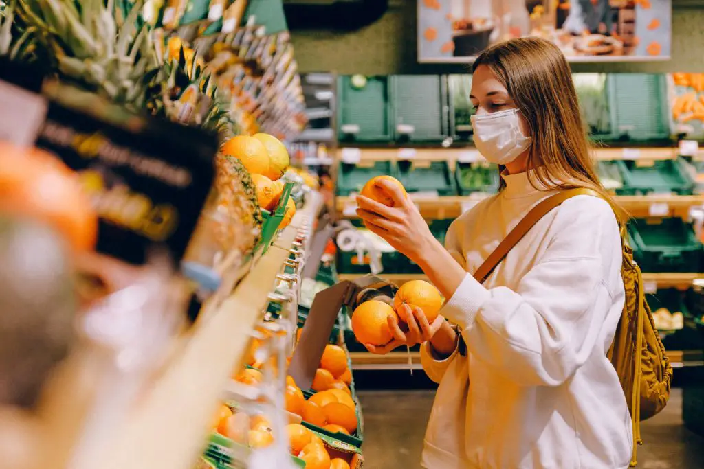 Photo of a female student buying fruits