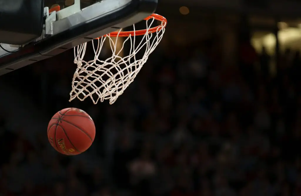 Photo of a basketball going through a hoop