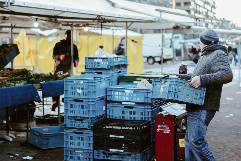 Photo of man carrying crates