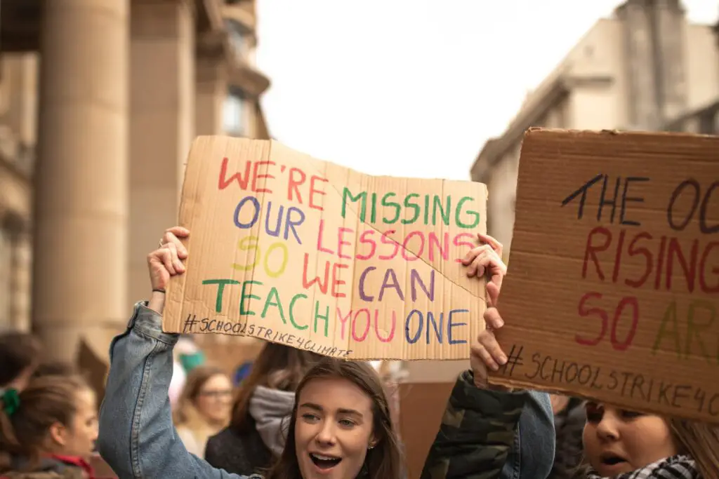 photo-of-student-activist-holding-sign-at-climate-protest