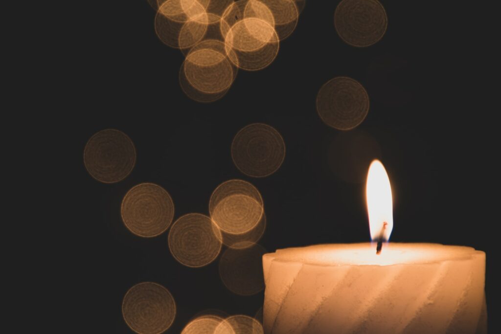 Photo of a candle during a memorial service