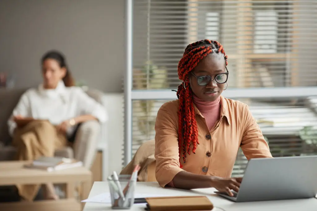 female college student searching for colleges with the best internships on her laptop