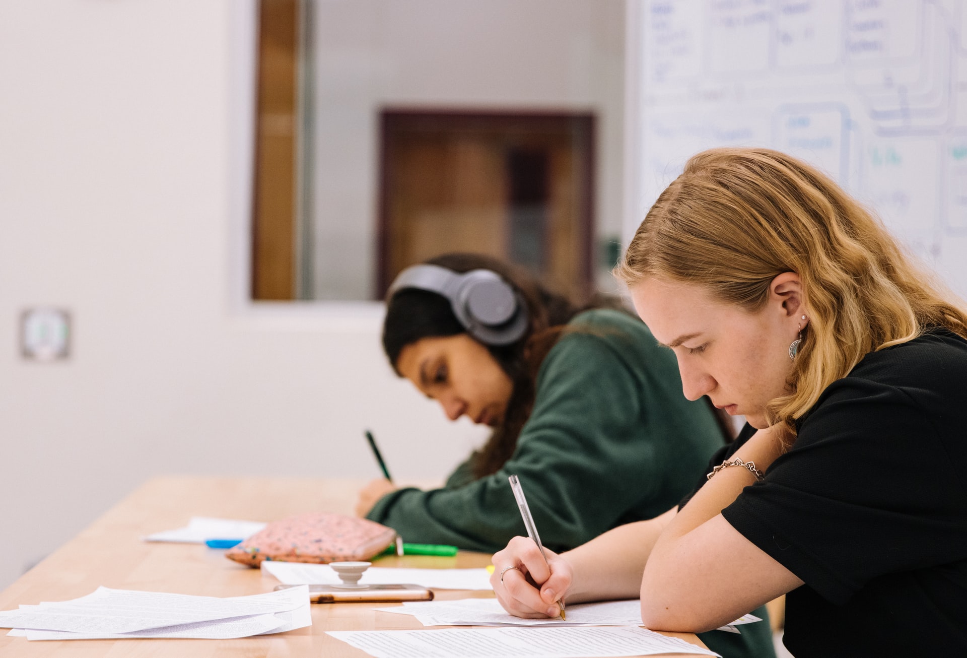 Photo of two students taking a test in a classroom