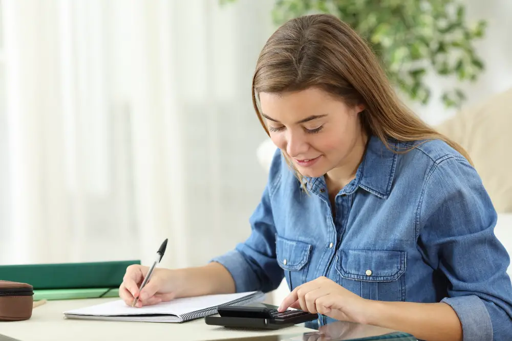 A happy blonde college freshman calculates the potential ROI on her declared college major