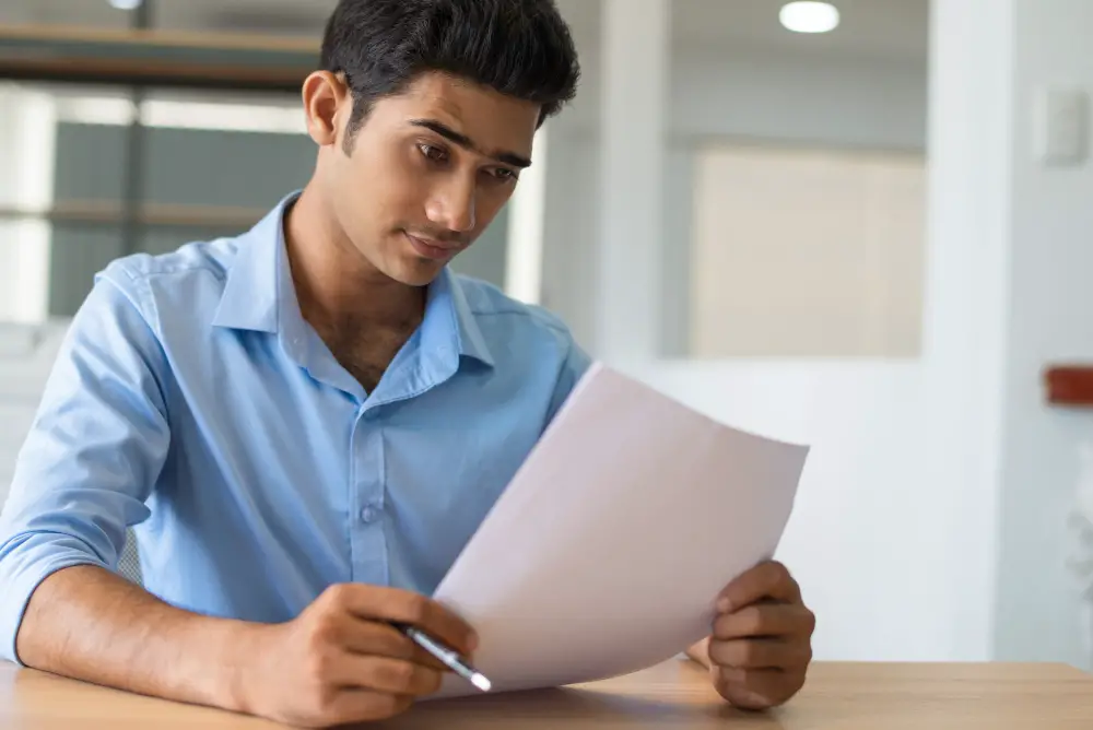 An Indian college freshman reads his application's instructions before writing down his chosen college major