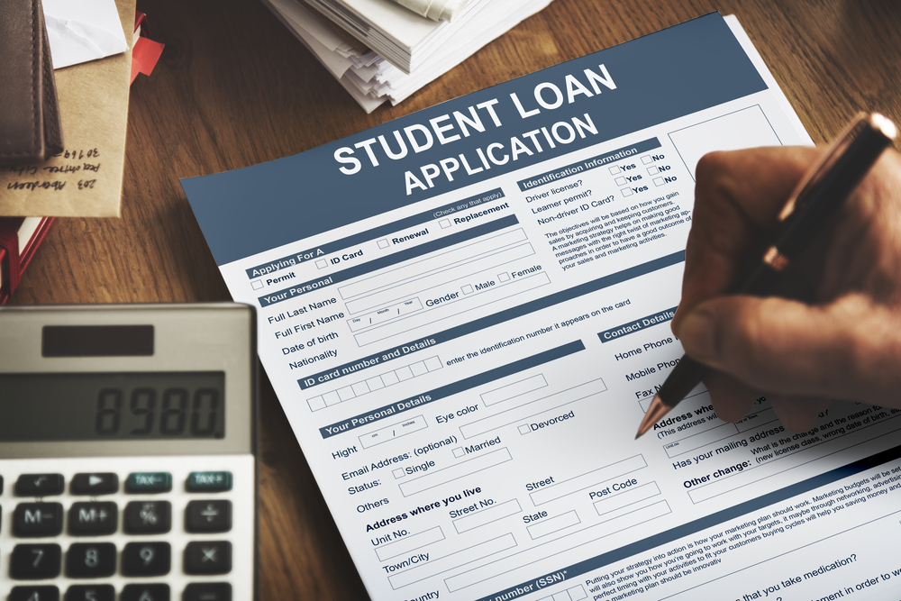 Student filling in student loan application form