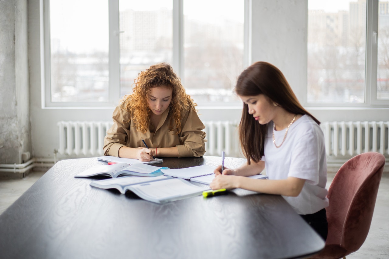 photo-of-two-girls-studying-with-cheap-college-textbooks