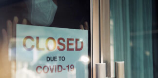 "Closed due to COVID-19" sign on the front door of a store