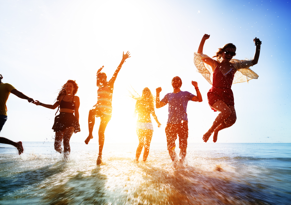 Students running out of the sea at Spring Break holiday