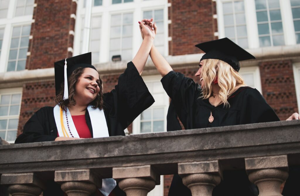 photo-of-two-college-graduates-with-scholarships-celebrating