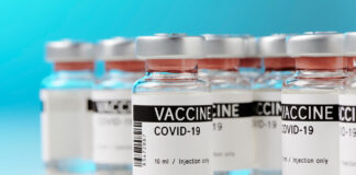 Ampoules with COVID-19 vaccine on a laboratory bench
