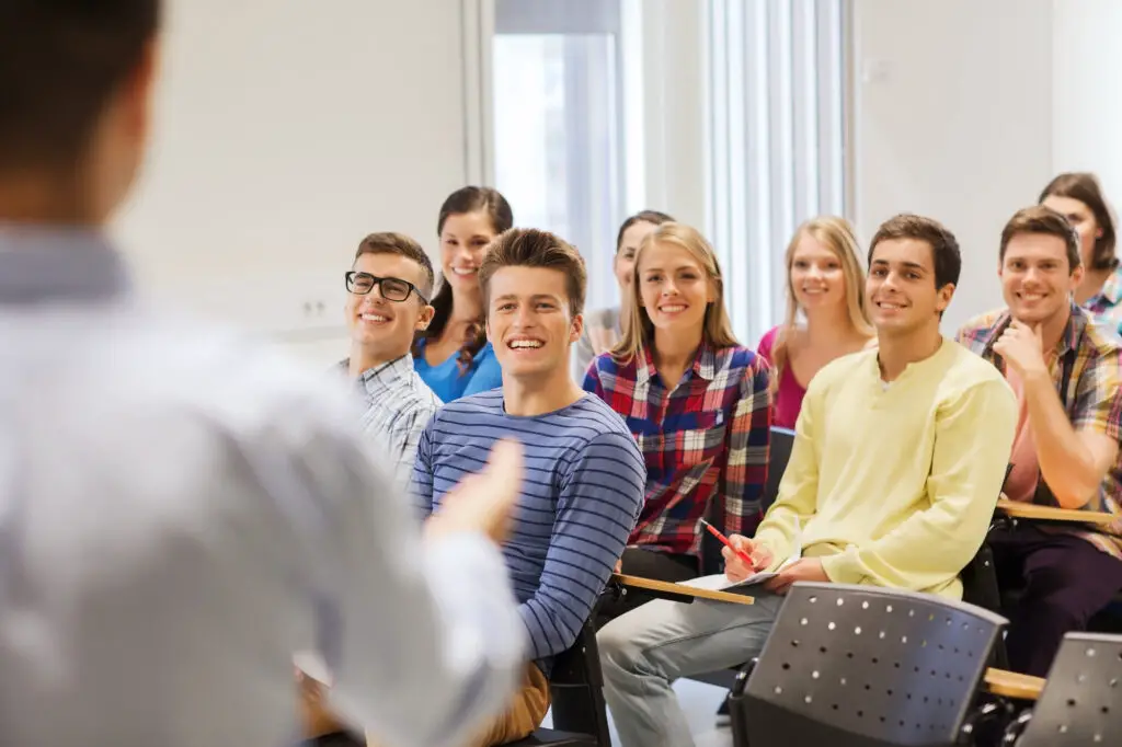 a group of male and female college students sitting in class for a review session
