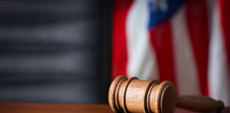 Judge's hammer with US flag in the background