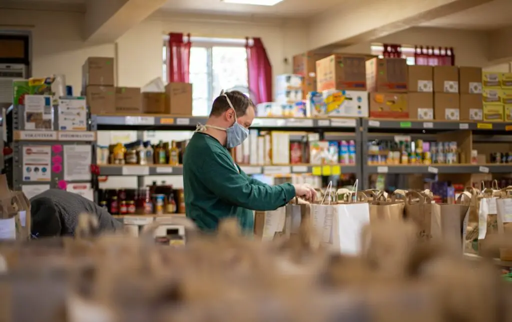 A man working in a food pantry during COVID