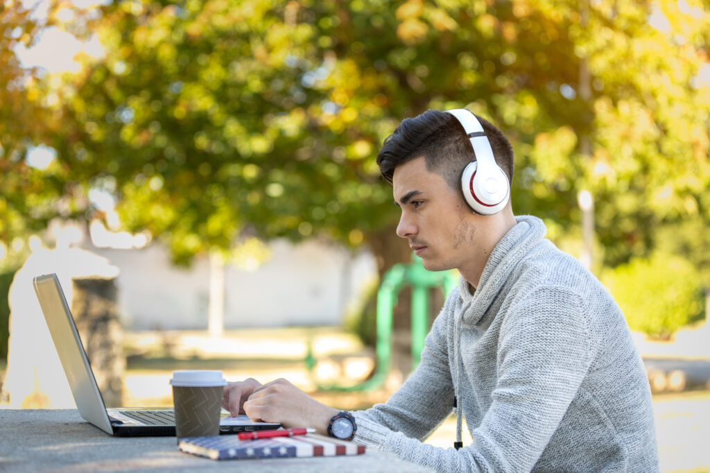 a male college applicant reviewing and proofreading his requirements before submitting his college application