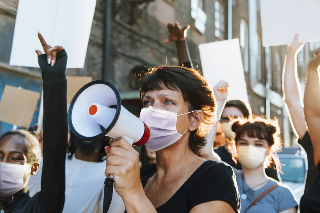 Diverse people wearing mask protesting during COVID-19 pandemic