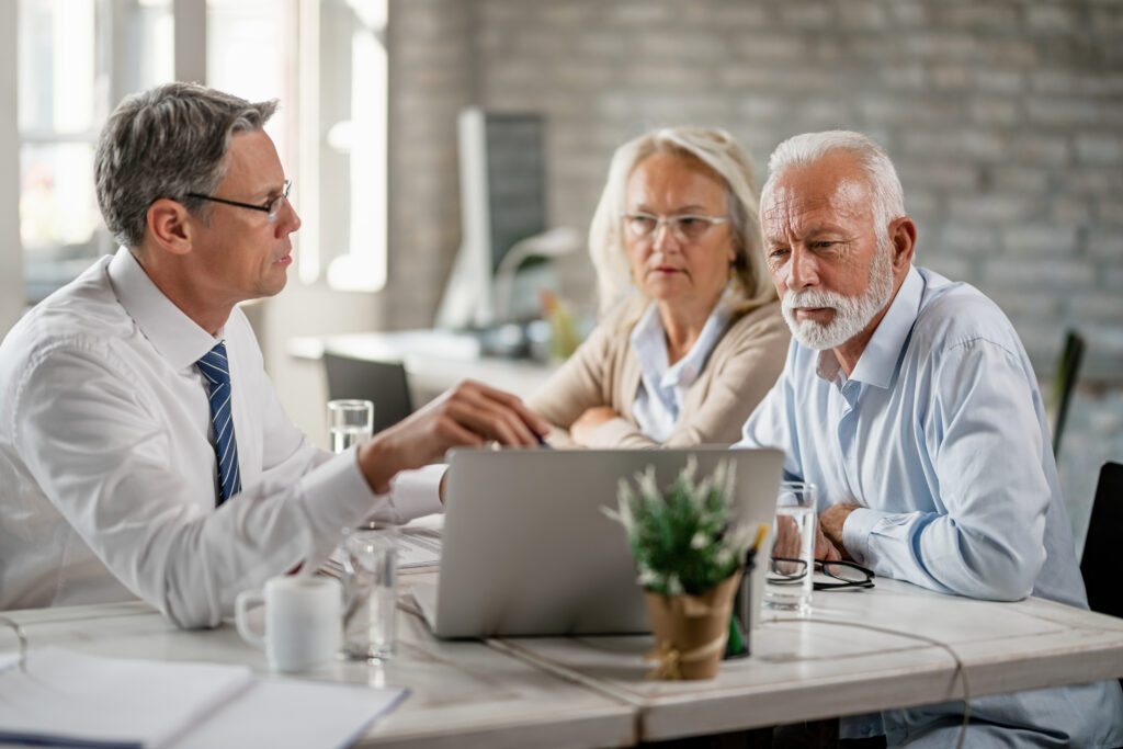 the parents of a college student are preparing their financial information with their banker or advisor to fill out the FAFSA