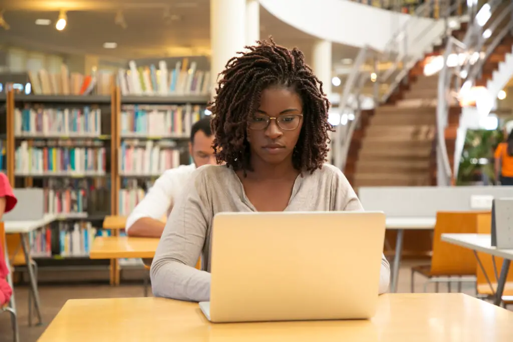 An African American student working on a laptop