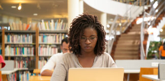 An African American student working on a laptop