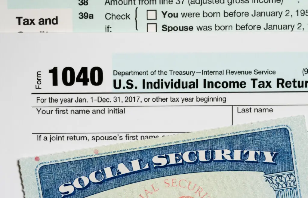 A US social security card with an SSN placed on top of tax records for college students to use to fill out FAFSA