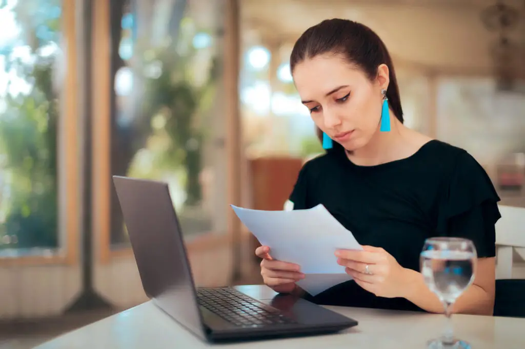 a female college student using her laptop to request for unofficial transcript and transfer college credits