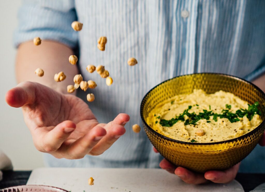 man prepares hummus as a healthy snack