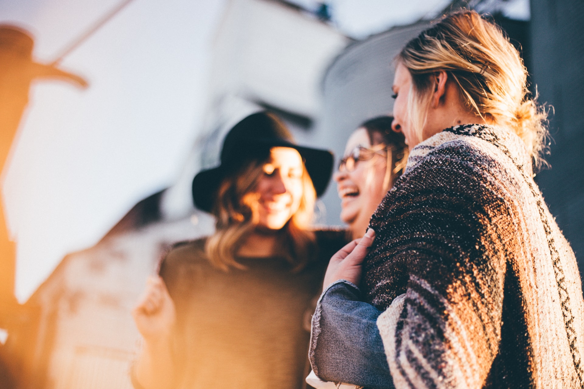 three-female-college-friends-standing-in-sun