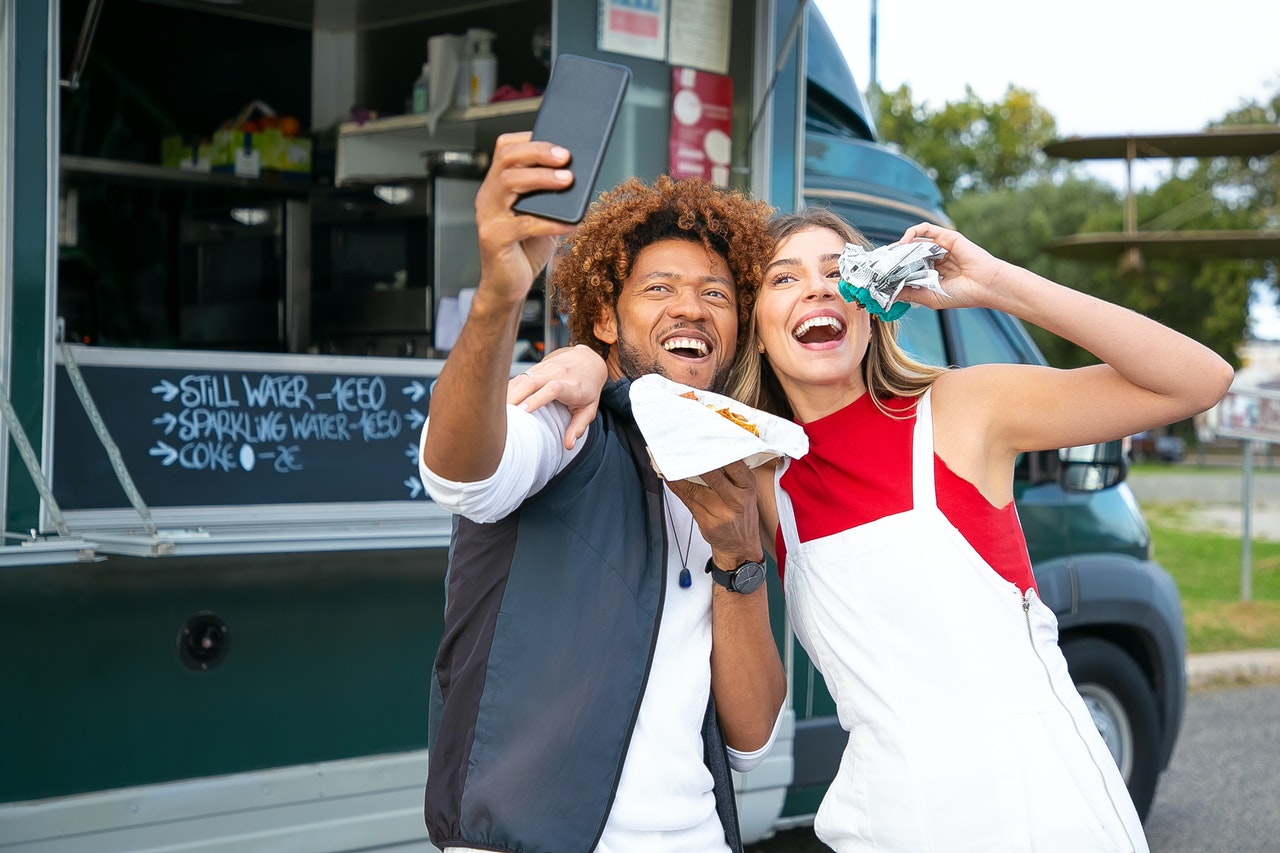 new-college-friends-at-food-truck-posing-for-selfie