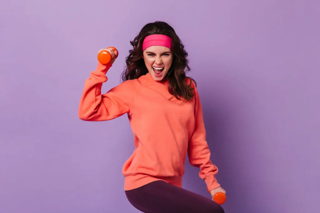 college-girl-staying-fit-with-weights-looking-at-camera