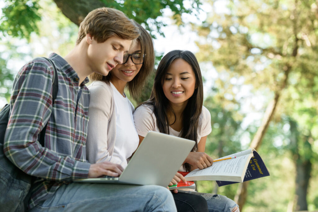 high-school-students-relaxing-in-park-after-early-action-admission