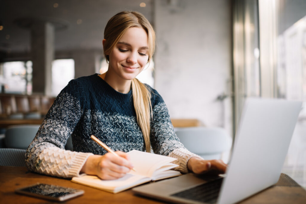 photo-of-college-student-creative-writing-at-laptop