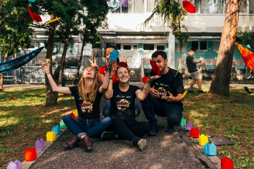 male and female students sitting on a pathway