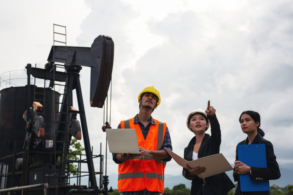 photo-of-petroleum-engineers-standing-by-oil-rig