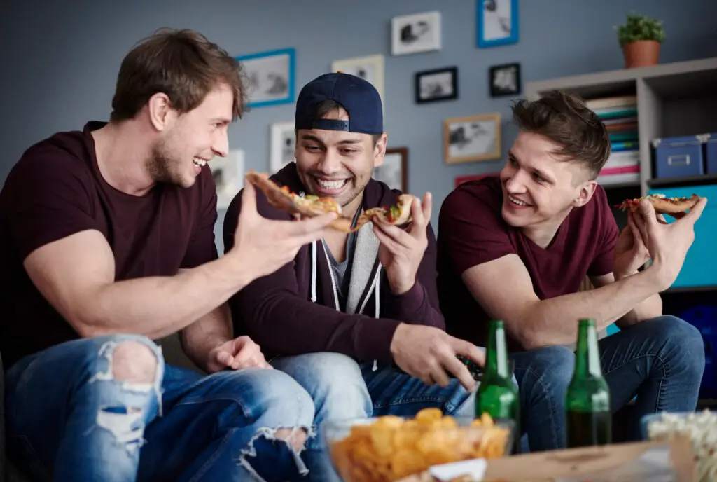 group-of-guys-eating-one-slice-of-pizza-each