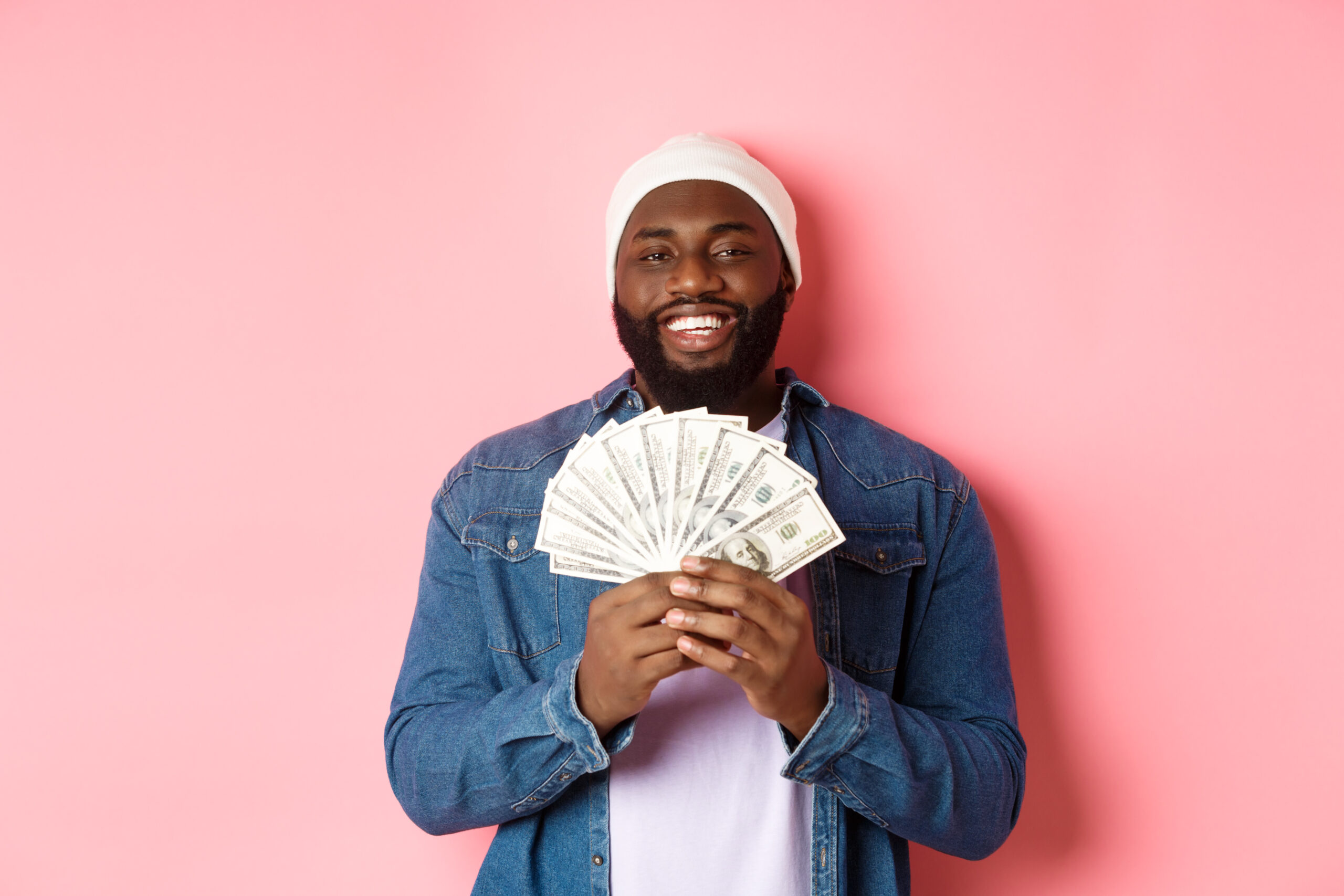 African American man holding cash