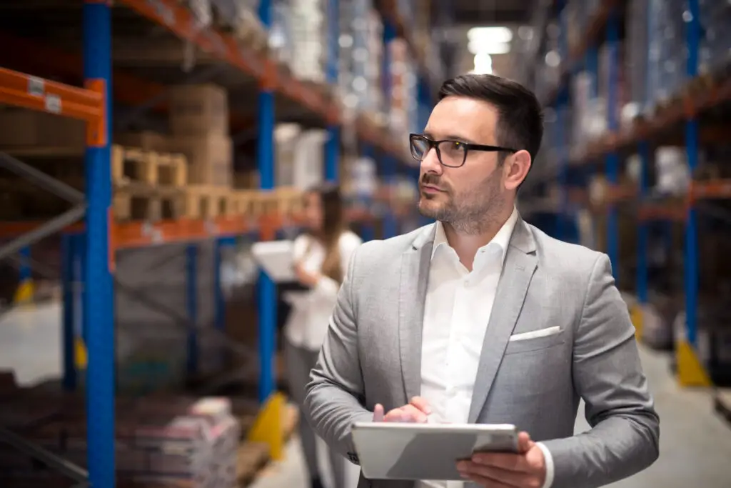 photo-of-man-with-logistics-degree-inside-warehouse-with-clipboard